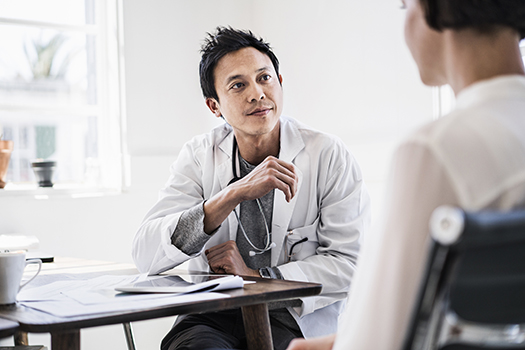 Doctor discussing with patient in hospital