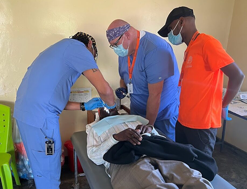 A CompHealth physician treats a patient during a clinic in Tanzania