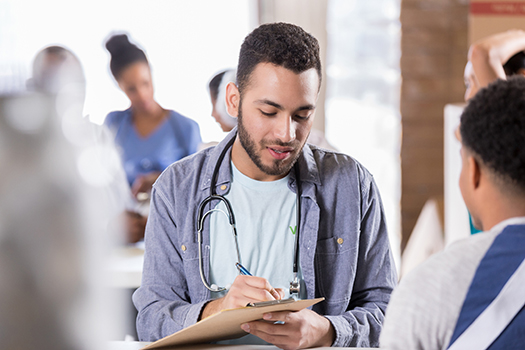 Doctor writing something in a notepad