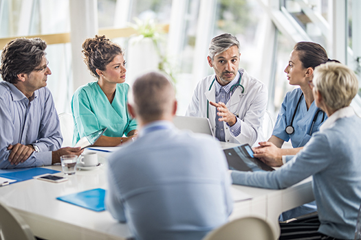 Physicians sitting around a table