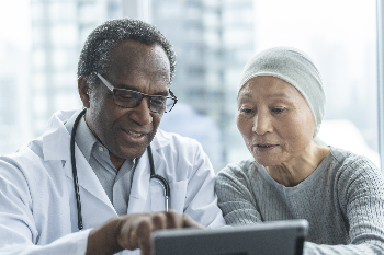 Physician and patient look at a tablet