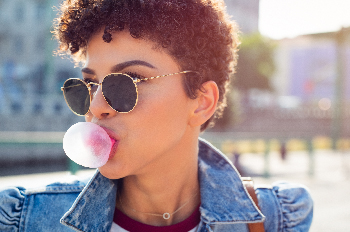 Woman blowing bubble gum