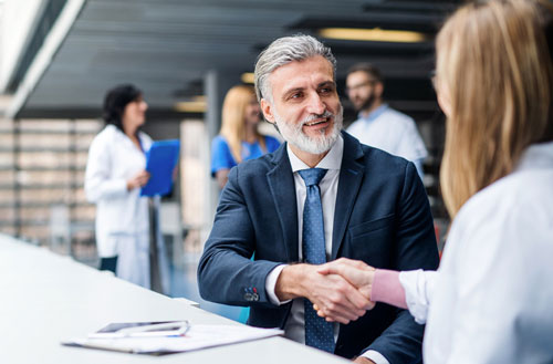 Hospital administrator greeting a locum tenens physician