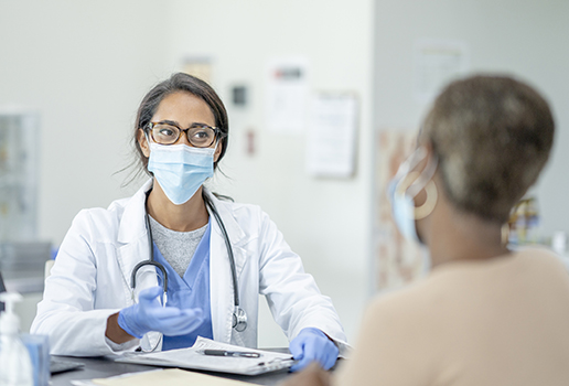 Physician wearing mask with a patient