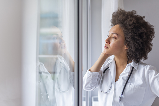 Physician looking out a window