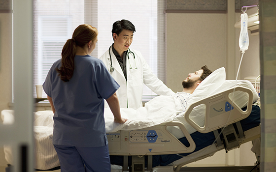 Doctor and nurse talking to patient in hospital