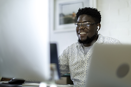 Physician recruiter working at a desktop computer