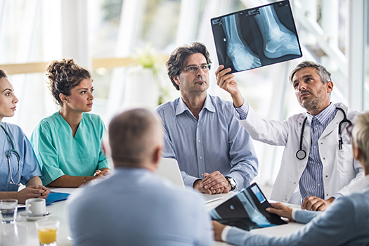 group of physicians analyzing x-ray
