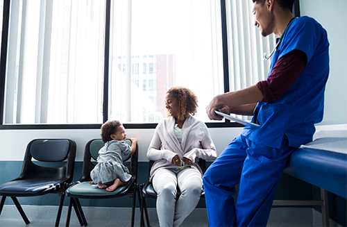 Physician in scrubs with patient