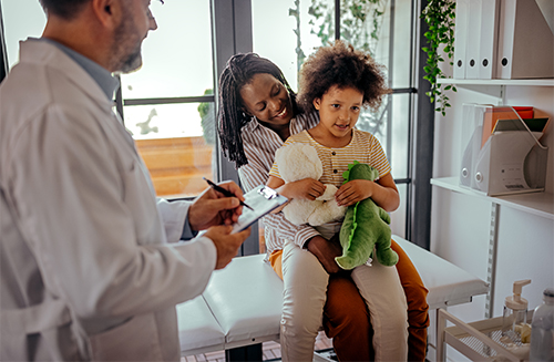 Physician with mom and daughter