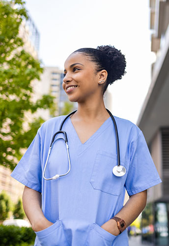 Physician standing outside of hospital on her first locum tenens assignment