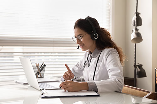 Telehealth physician talking on computer